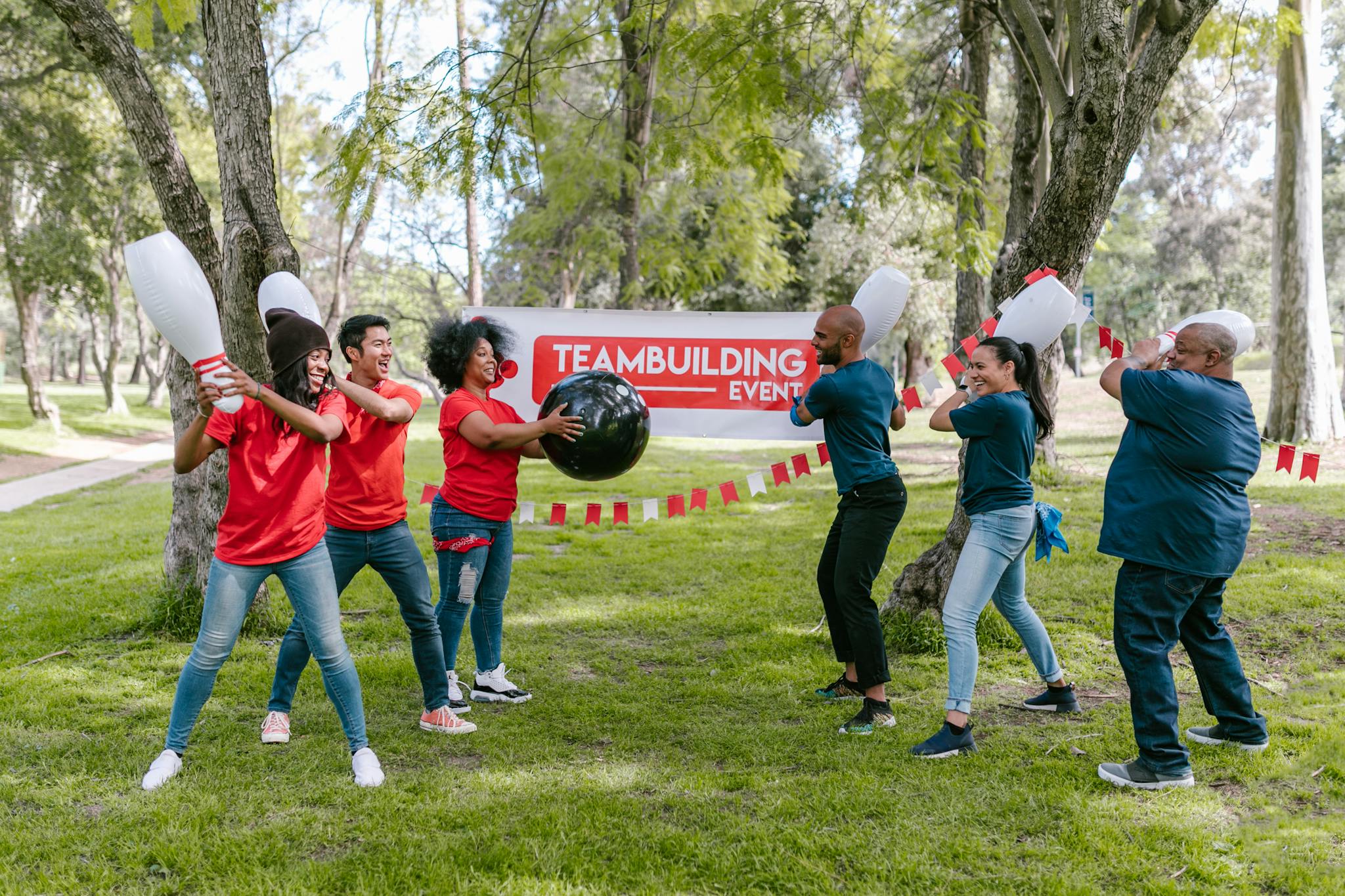 Dynamic outdoor team building activity with diverse group playing in the park.
